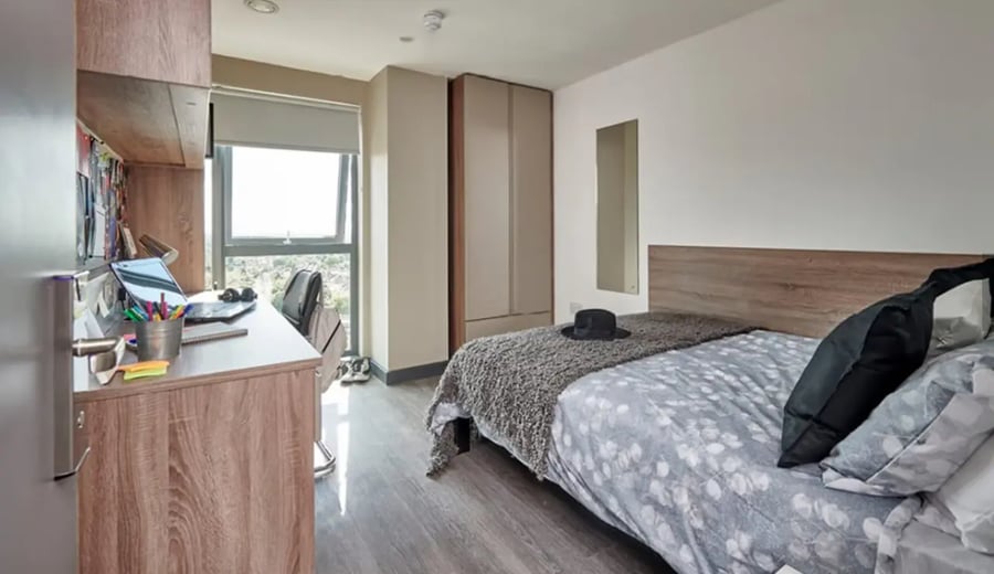 Desk with laptop and bed with hat bedroom at Trinity View Coventry in Coventry Student Accommodation